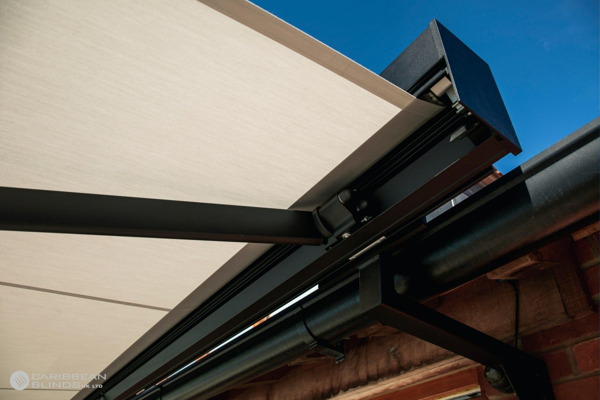 Automated awning mechanism in black aluminium with cream fabric